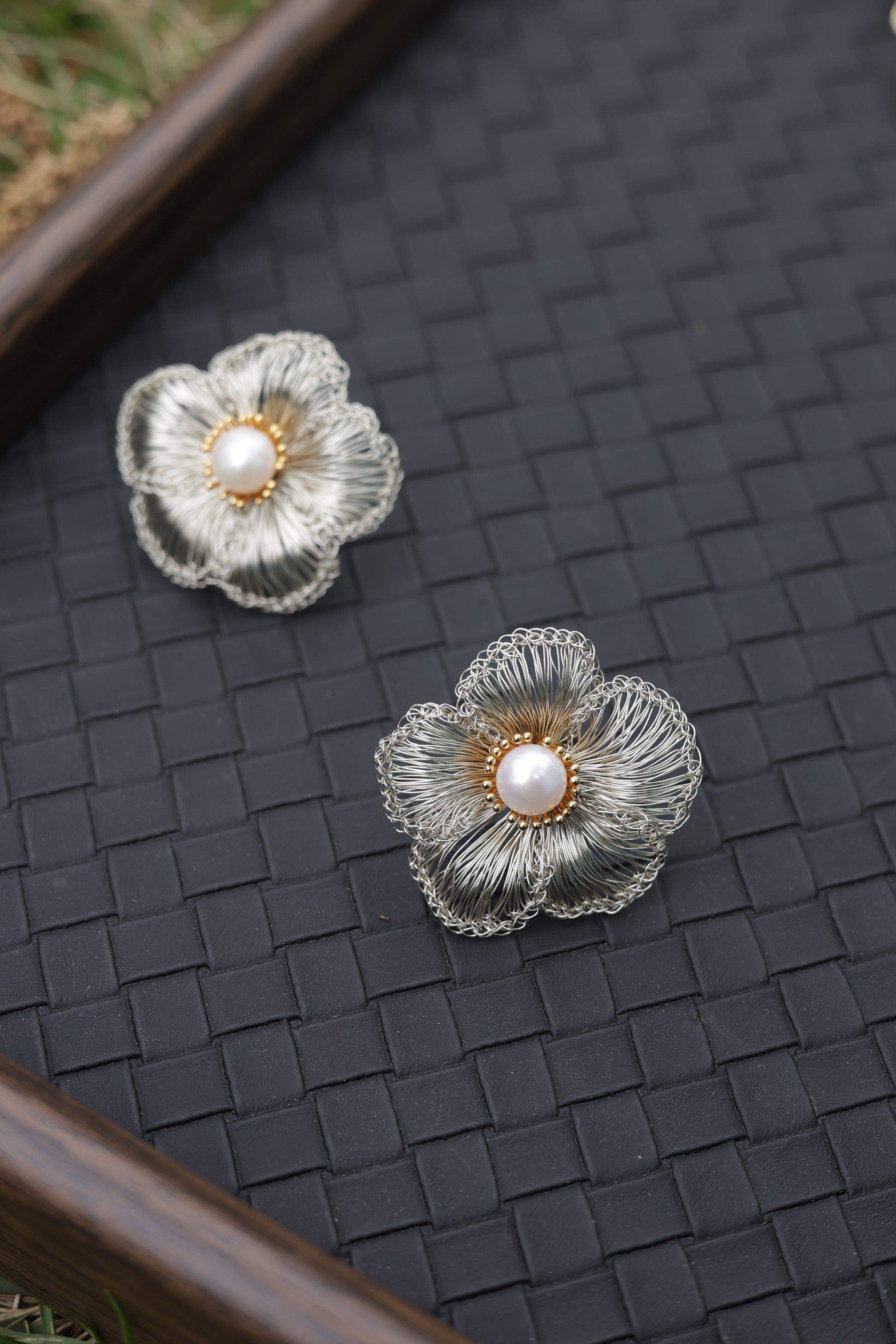 Silver petal pearl earrings on model