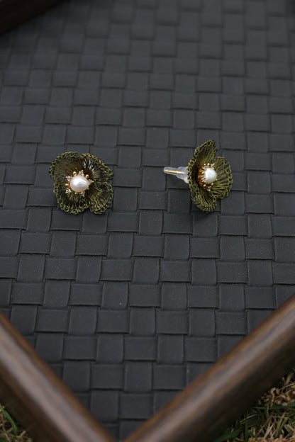 Moss green petal pearl earrings on model side view