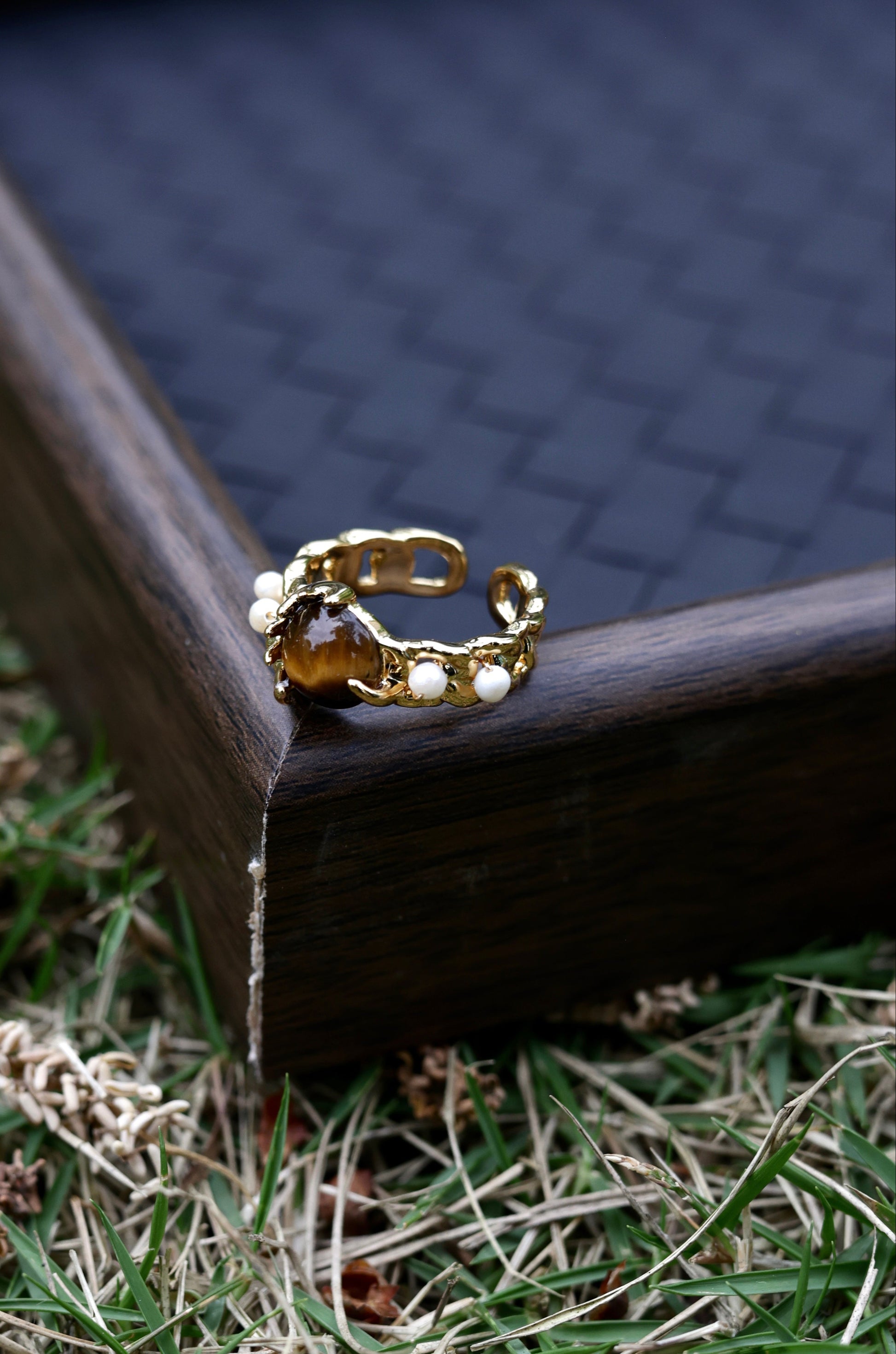 Amber stone pearl ring on hand front view