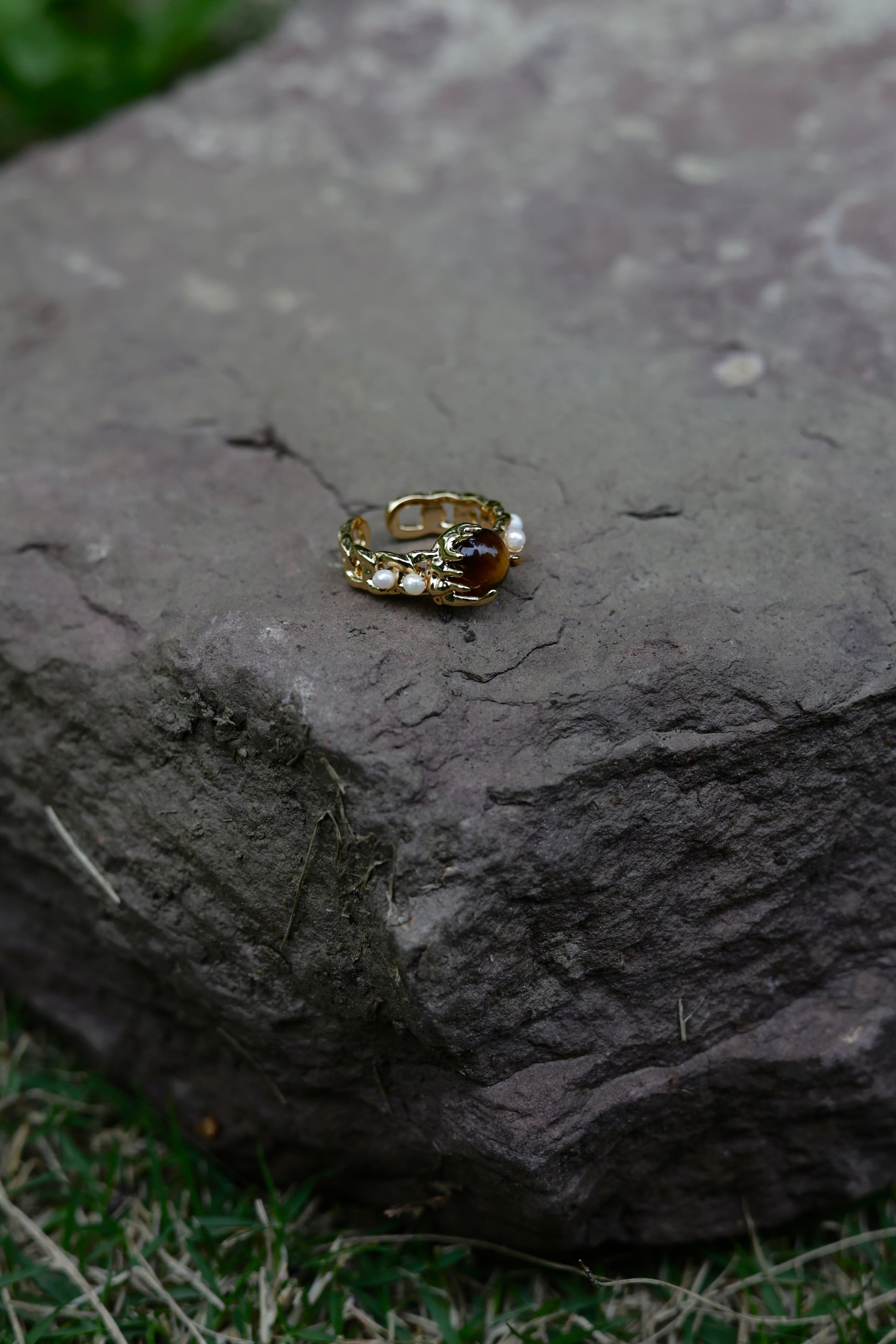 Amber stone pearl ring flat lay detail