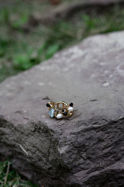 Stone cluster pearl ring flat lay detail