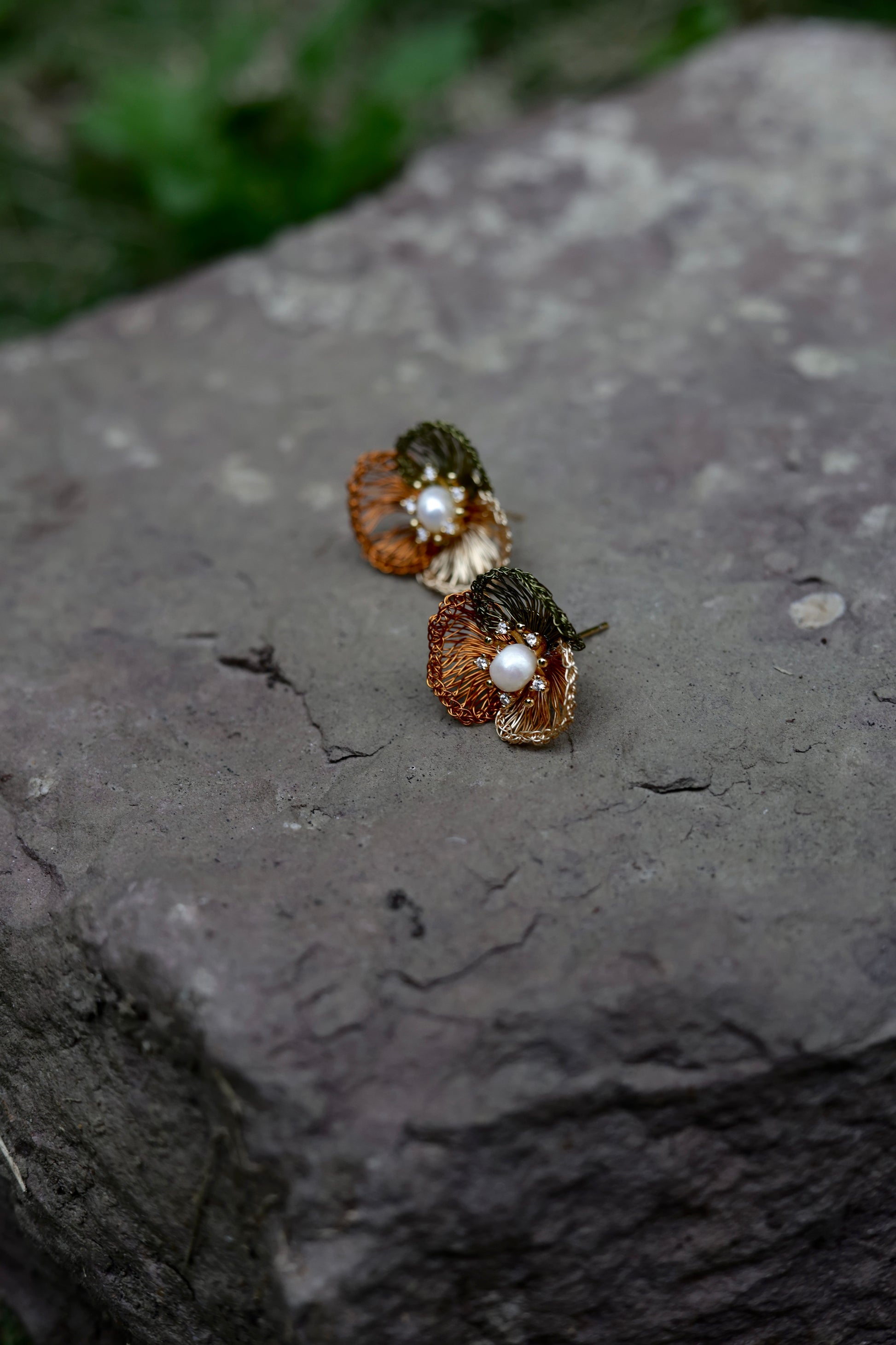 Earth tone petal pearl earrings on model